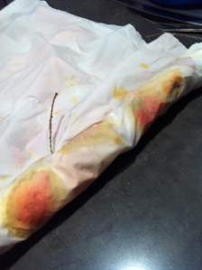 Starting to roll along the long length from the open edges.  this allows the fold to be filled with material as it shifts under pressure, meaning no empty strip down the centre!  Note colour emerging more now.