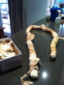 The whole sheeet is now tied as tightly as possible with "bandages" of cotton strips which have been used in this way before, hence their gorgeous colours!