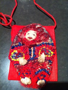 An embroidered "person" fronting a bag