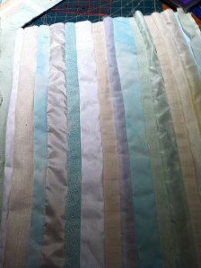 Some of the previously dyed strips mixed with new ones and pieced along their length