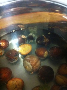 Frozen avocado pips go into the pan with water.