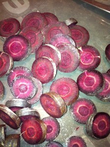 Sliced purple carrot in water before boiling