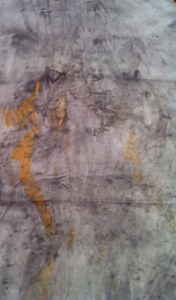 Previously dyed bamboo sheeting scrap with a eucalyptus leaf added and iron spray.