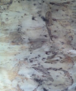 Hitherto undyed cotton sprayed with iron with leaves and lavender bound tightly into it.