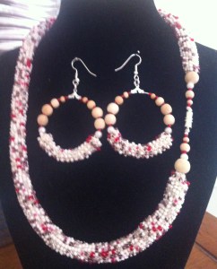 A mix of cream beads with some tan and some red crocheted with cream cotton embroidery thread